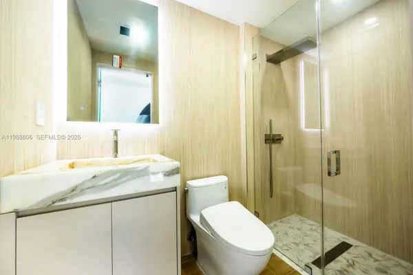 a view of a room with wooden floor and white walls