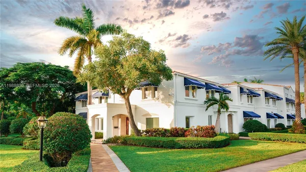 a front view of a house with a garden