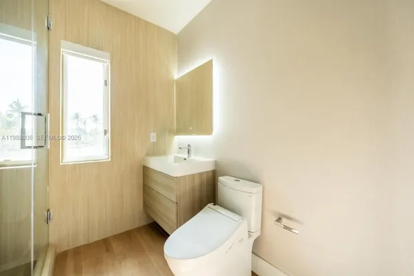 an empty room with a ceiling fan and wooden floor