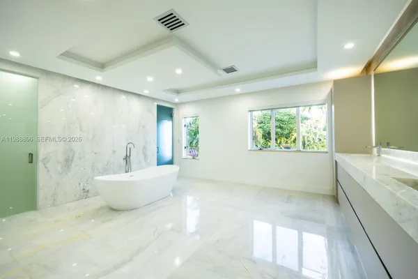a view of a bedroom with wooden floor and windows