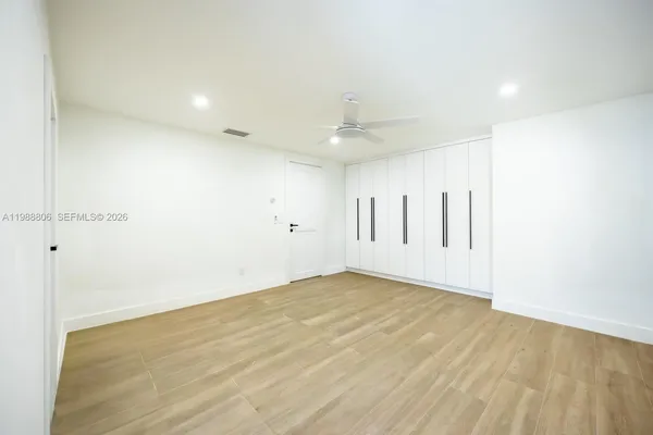 a view of a livingroom with wooden floor and a fireplace