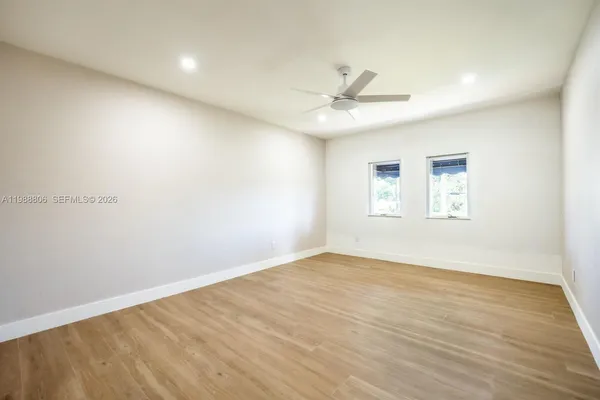 a large kitchen with stainless steel appliances granite countertop a stove a sink and a microwave