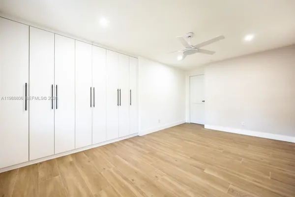 a large kitchen with kitchen island a sink stainless steel appliances and cabinets