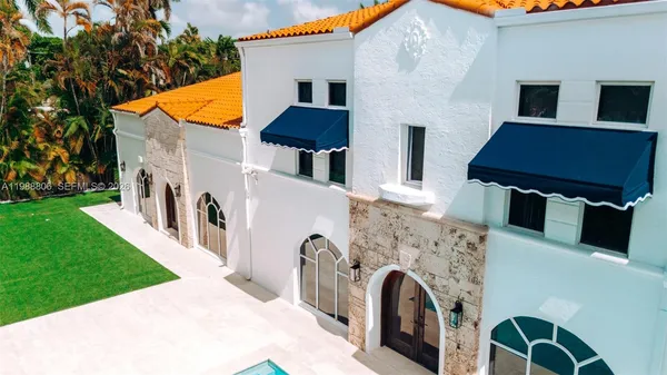 a view of an house with swimming pool and front view of a house