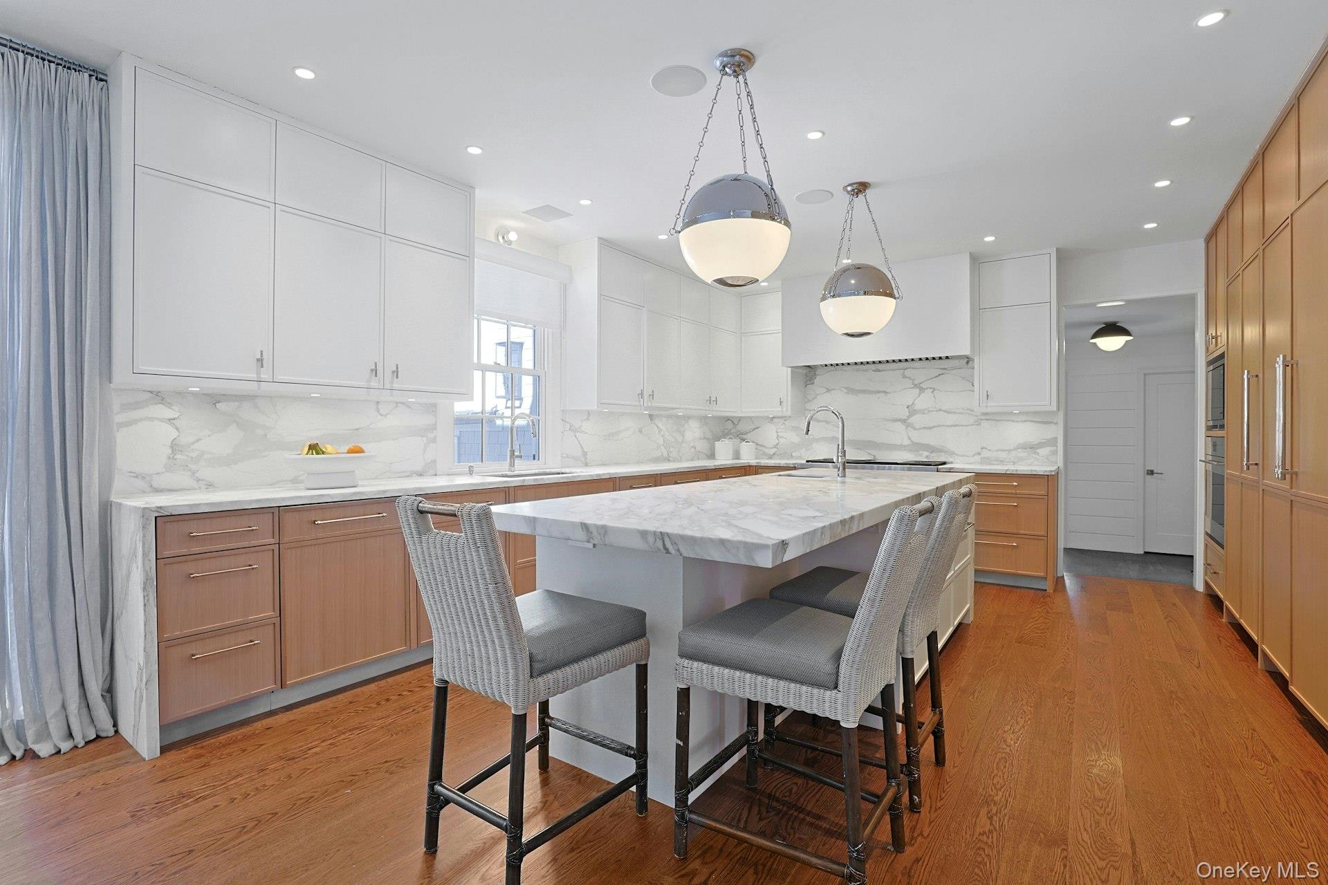 19 Overlook Road Scarsdale, NY 10583 - Photo 16 of 50 a kitchen with a table chairs sink and cabinets
