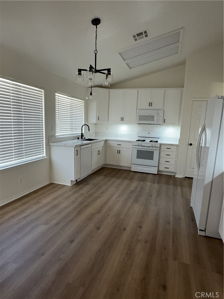12590 Cobalt Road Victorville, CA 92392 - Photo 20 of 37 a large kitchen with a wooden floor and stainless steel appliances