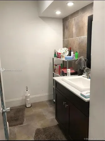 a bathroom with a sink toilet and a mirror