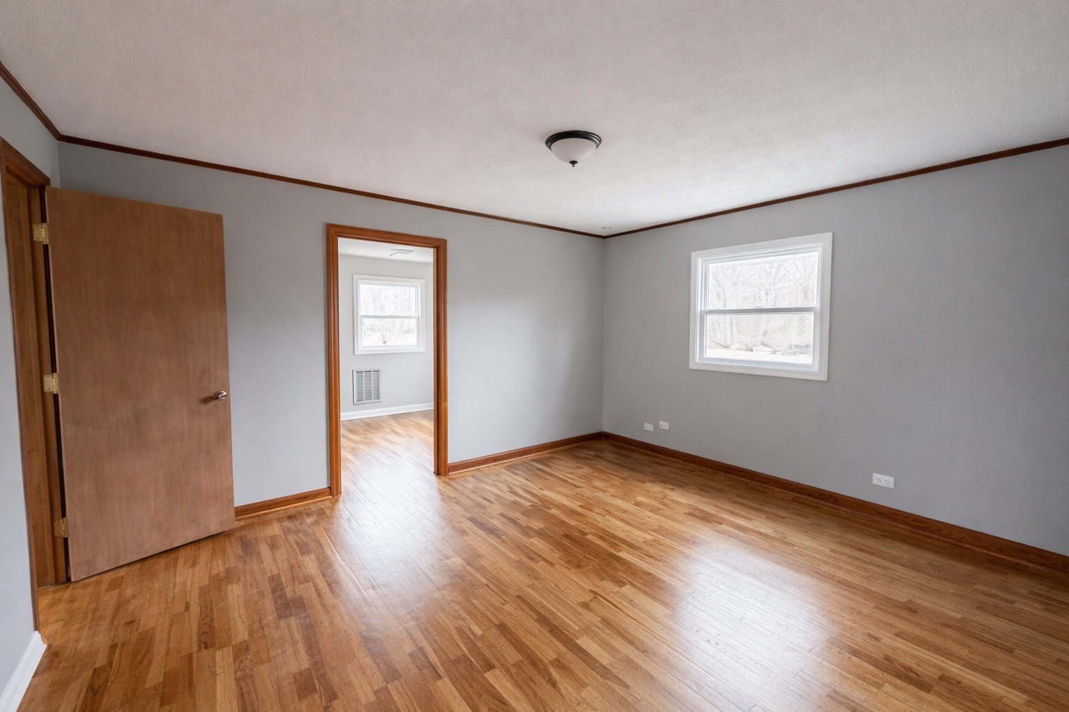 109 Apple Tree Street Arlington, KY 42021 - Photo 15 of 18 an empty room with wooden floor and windows