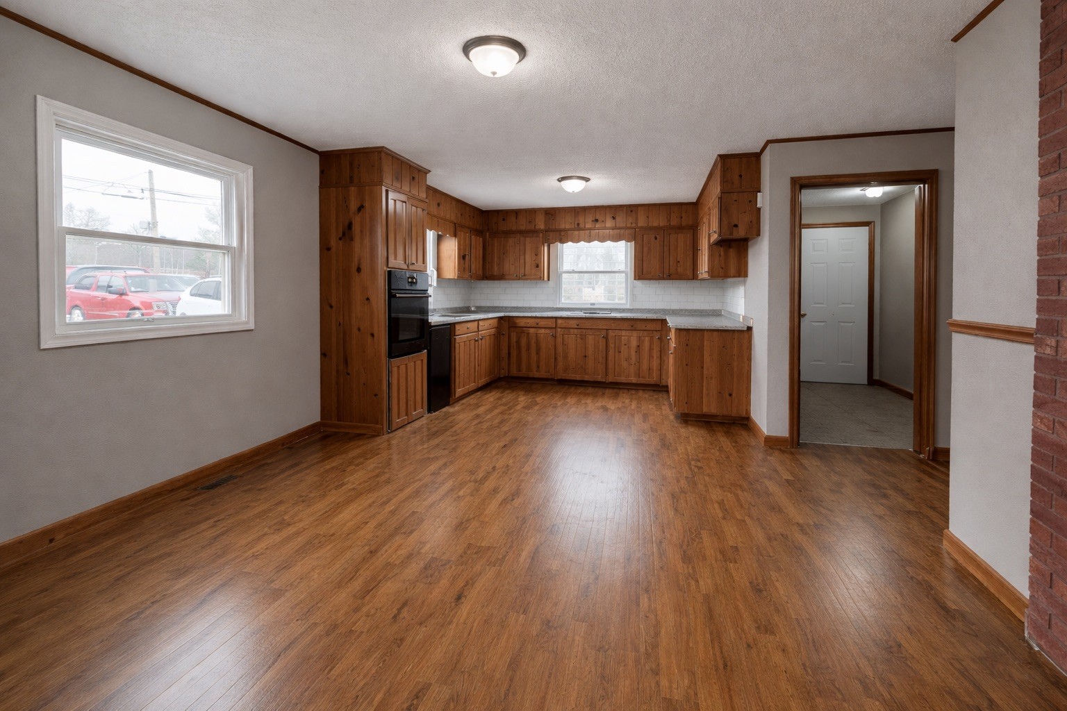 109 Apple Tree Street Arlington, KY 42021 - Photo 3 of 18 a kitchen with stainless steel appliances wooden floors and large window