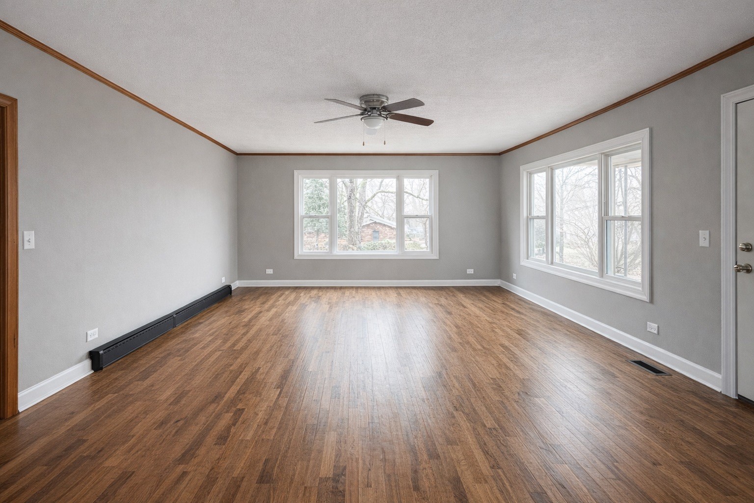 109 Apple Tree Street Arlington, KY 42021 - Photo 6 of 18 an empty room with wooden floor windows and a ceiling fan