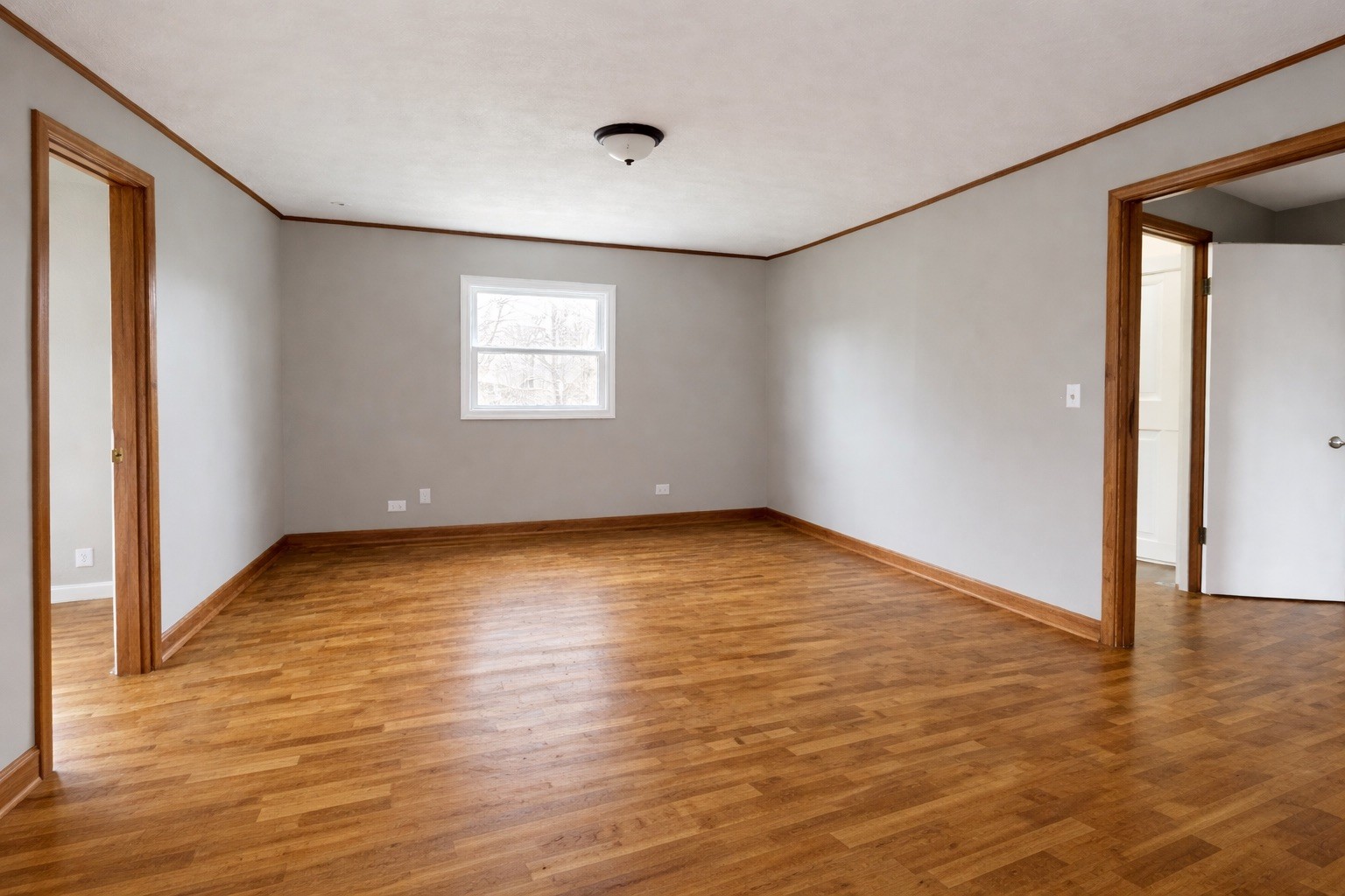 109 Apple Tree Street Arlington, KY 42021 - Photo 8 of 18 an empty room with wooden floor and windows