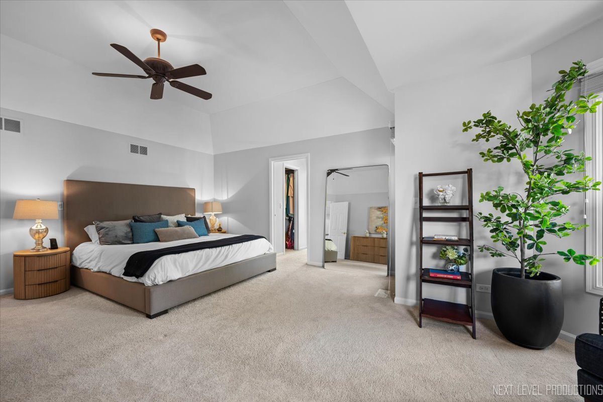 2236 Red Maple Lane Aurora, IL 60502 - Photo 11 of 50 a spacious bedroom with a bed and a potted plant