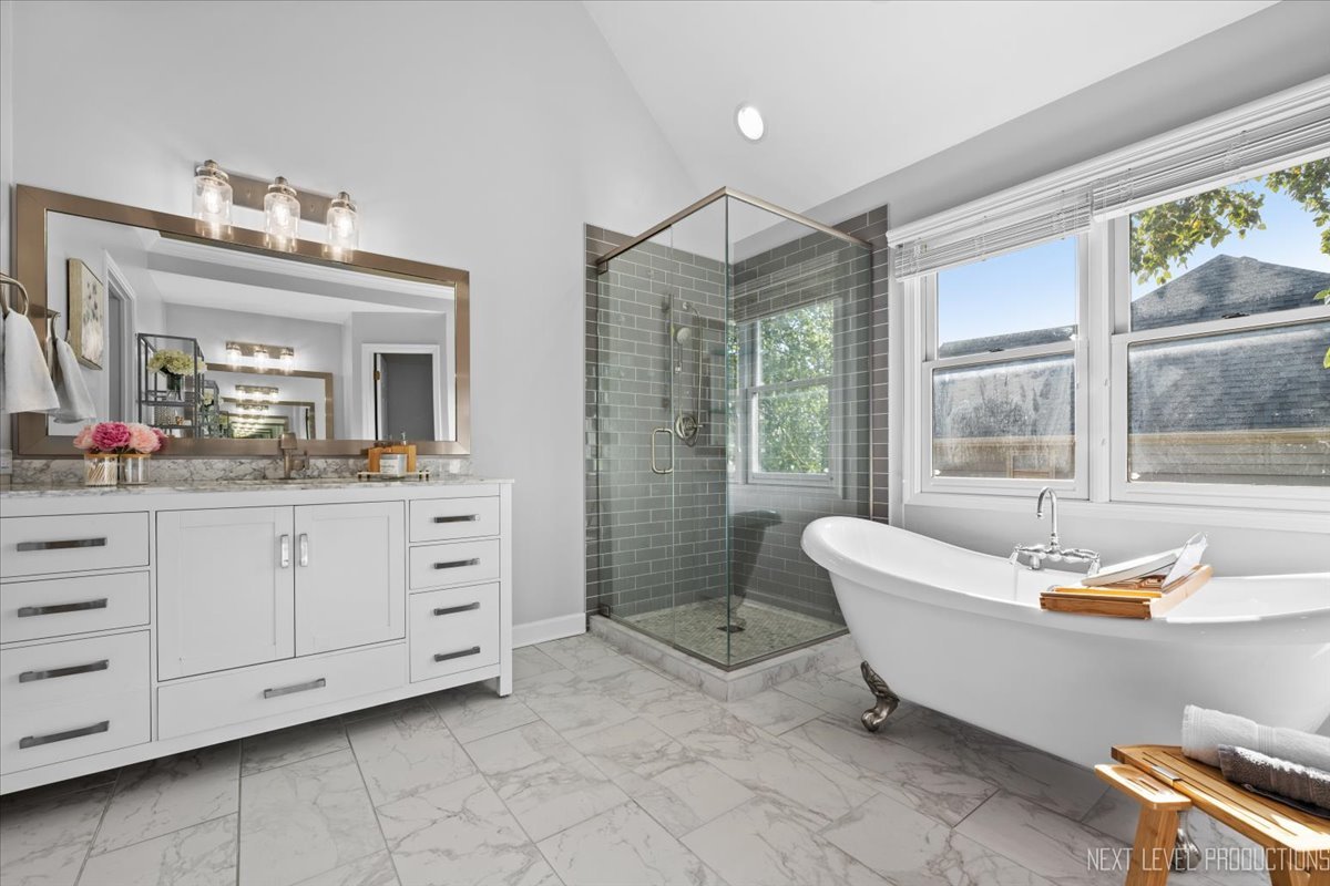 2236 Red Maple Lane Aurora, IL 60502 - Photo 12 of 50 a spacious bathroom with a double vanity sink large mirror and a bathtub