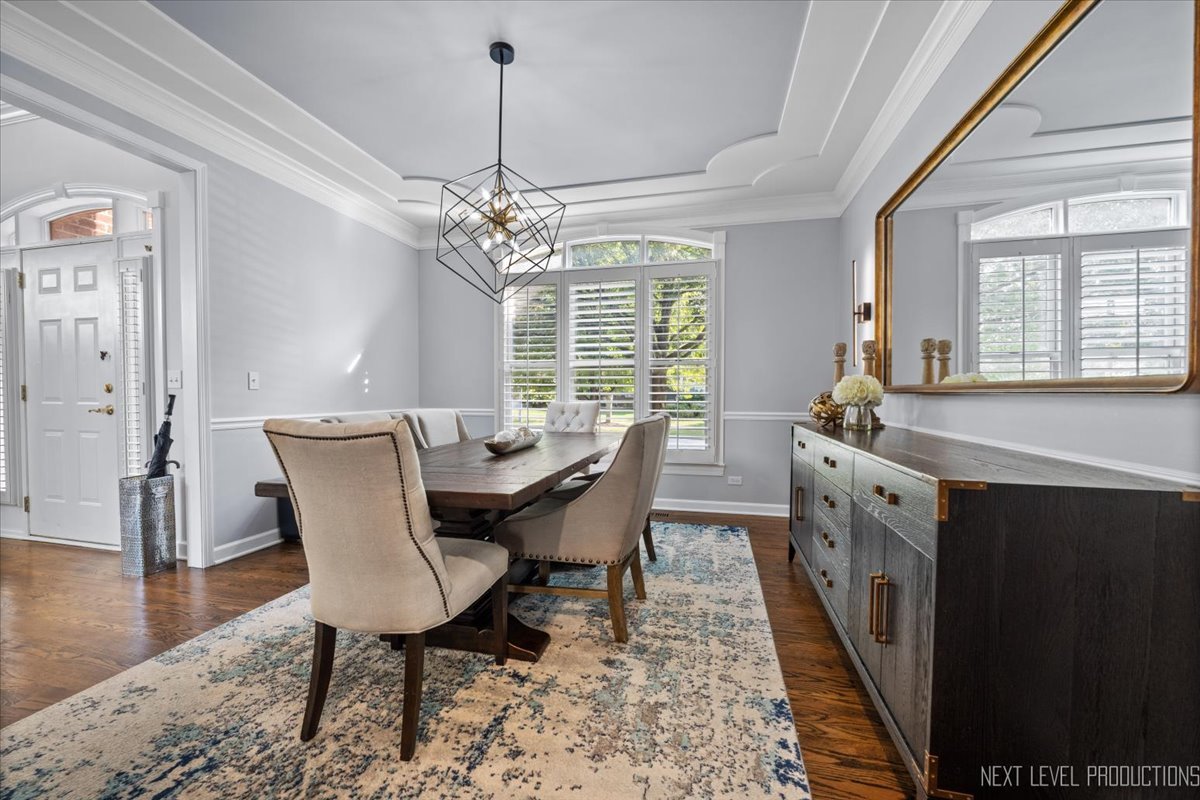2236 Red Maple Lane Aurora, IL 60502 - Photo 13 of 50 a dining room with furniture a chandelier and wooden floor