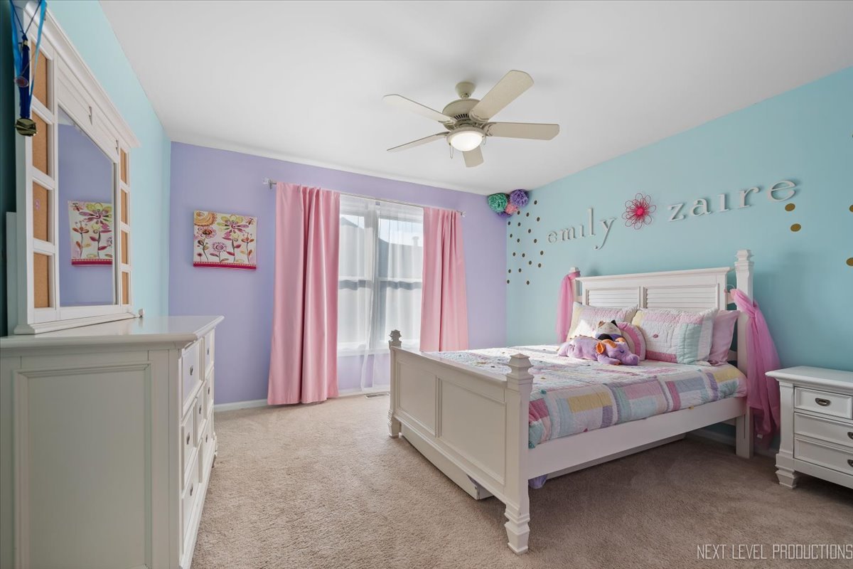 2236 Red Maple Lane Aurora, IL 60502 - Photo 28 of 50 a bedroom with a bed and a chandelier