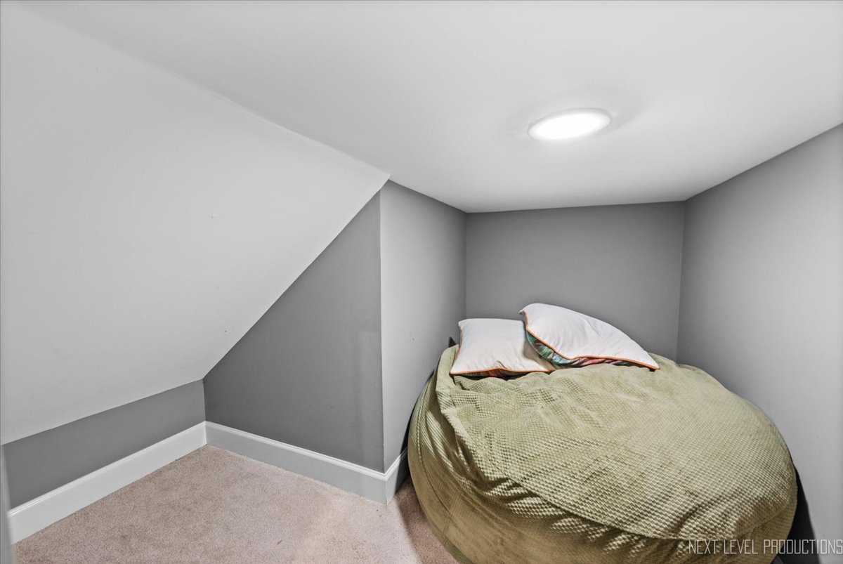 2236 Red Maple Lane Aurora, IL 60502 - Photo 36 of 50 a view of a room with a ceiling fan and wooden floor