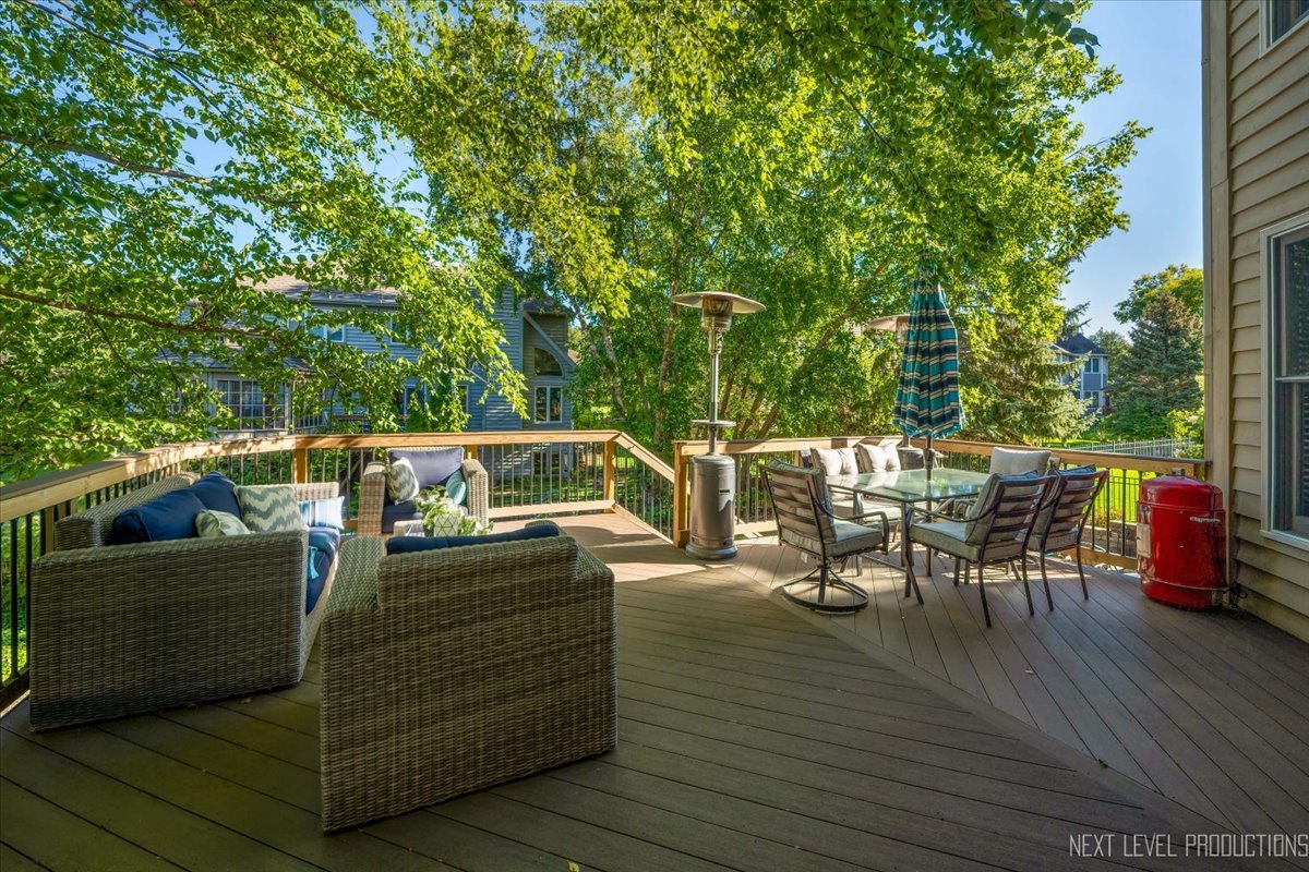 2236 Red Maple Lane Aurora, IL 60502 - Photo 41 of 50 a view of a patio with table and chairs with wooden floor and fence