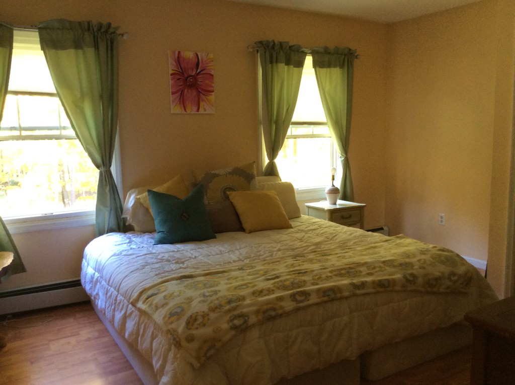 46 Old Village Road Sturbridge, MA 01566 - Photo 9 of 18 a large bed sitting in a bedroom next to a window