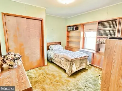 a bedroom with a bed and a window in it