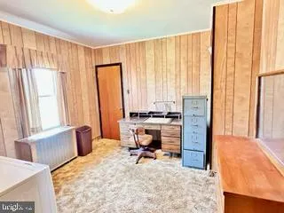 a view of workspace with furniture and window