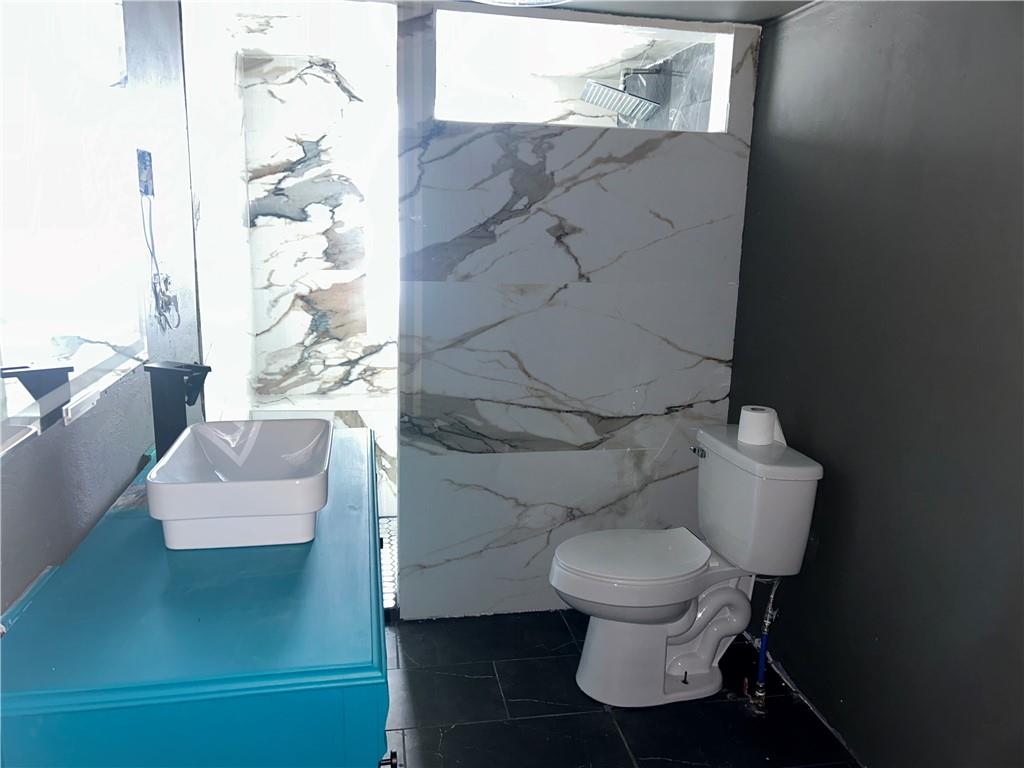 1300 Townline Road Mayport, PA 16240 - Photo 22 of 32 a white toilet sitting next to a bathroom sink and a mirror