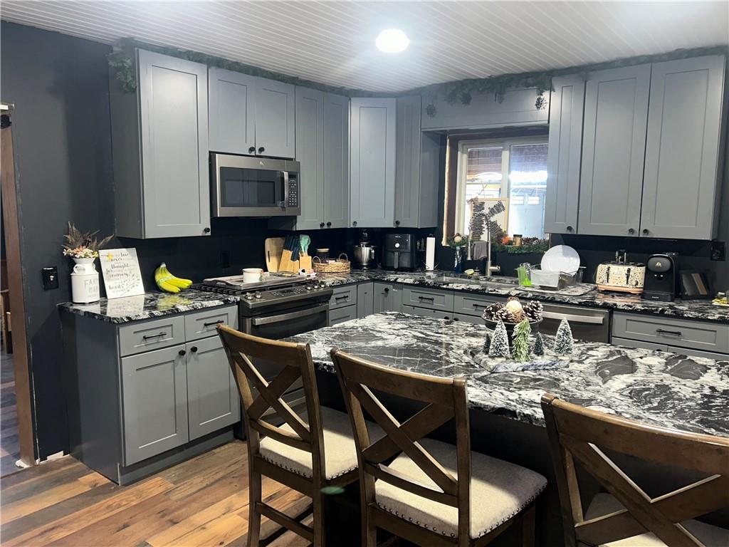 1300 Townline Road Mayport, PA 16240 - Photo 4 of 25 a kitchen with stainless steel appliances granite countertop a stove top oven a dining table and chairs