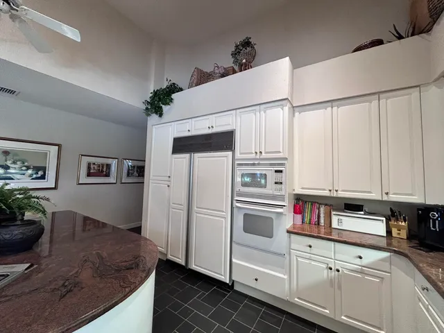 a living room with furniture a large window and a fireplace