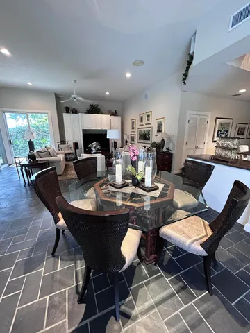 a living room with furniture fireplace and a large window