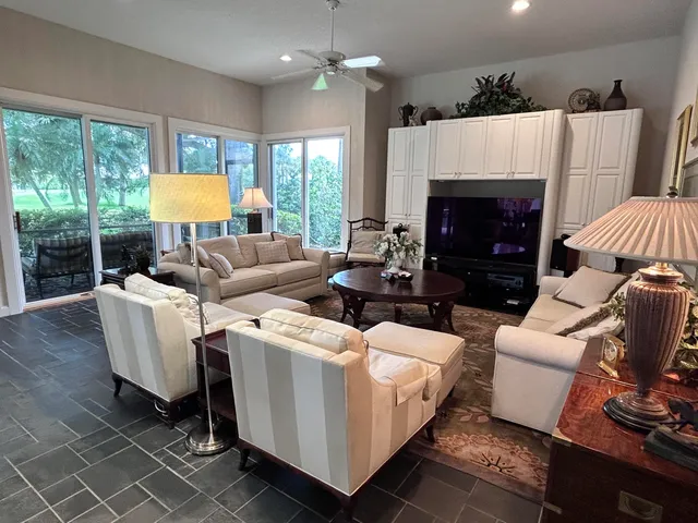 a large kitchen with kitchen island a sink counter top space a large window and stainless steel appliances