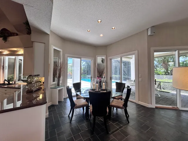 a living room with furniture hard wood floor and a window