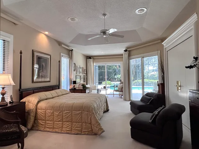 a bedroom with a bed lamps and a chandelier