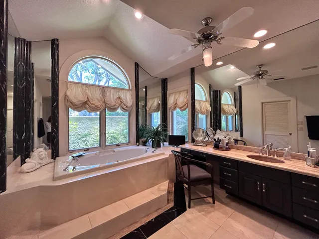 a bathroom with double vanity sink and a mirror
