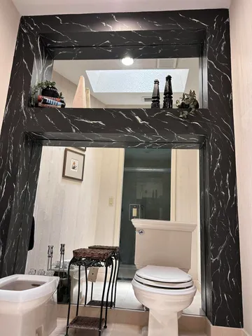 a bedroom with a bed and a lamp