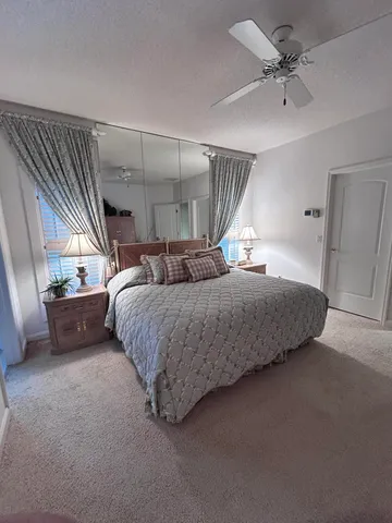 a bedroom with two beds and painting on the wall