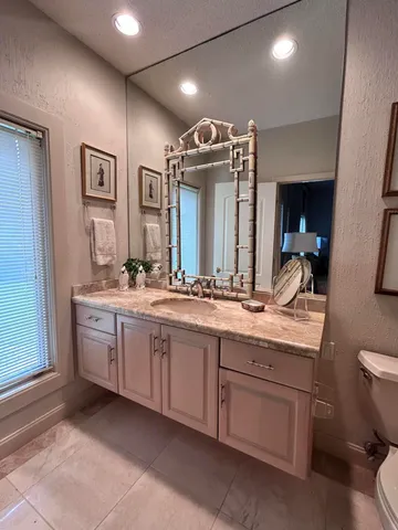 a kitchen with granite countertop a sink a stove and cabinets