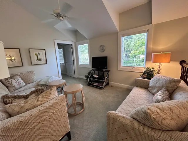 a view of a porch with furniture and a yard