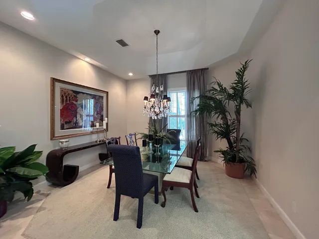 a dining room with furniture and a chandelier
