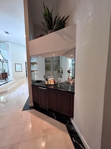 a living room with a black white checkered floor and a fireplace