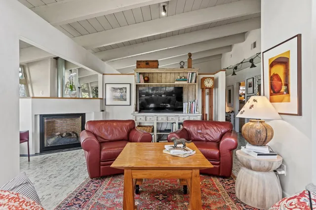 a bathroom with a sink a toilet and a shower curtain