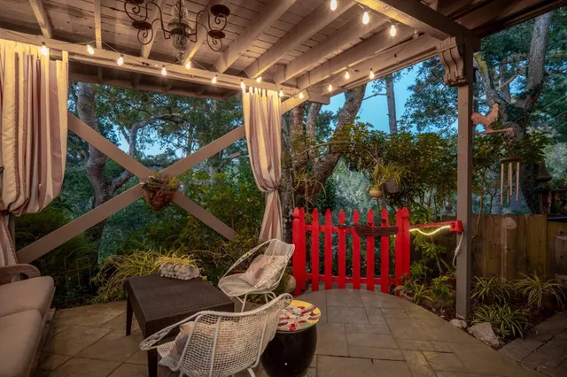 a view of deck with furniture and umbrella