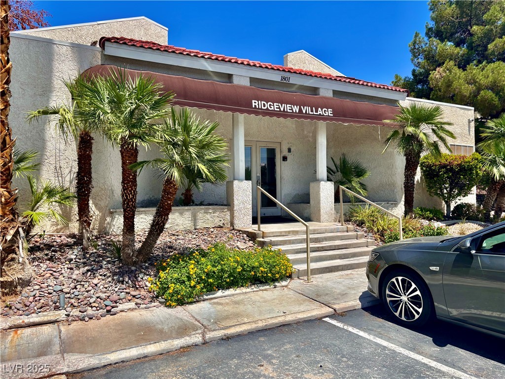2011 Cutlass Drive Henderson, NV 89014 - Photo 1 of 41 View of front facade with stucco siding, uncovered parking, and a tile roof