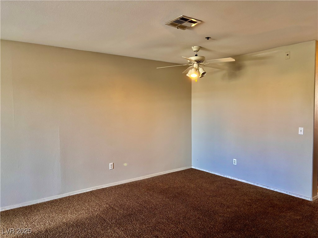 2011 Cutlass Drive Henderson, NV 89014 - Photo 22 of 41 Unfurnished room with dark carpet and a ceiling fan