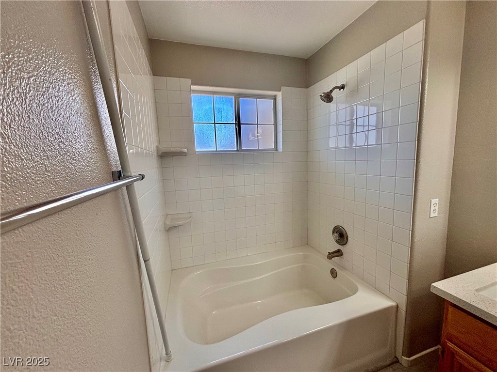 2011 Cutlass Drive Henderson, NV 89014 - Photo 25 of 41 Full bathroom with vanity, bathing tub / shower combination, and a textured wall