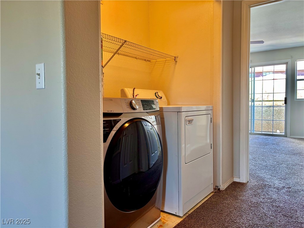 2011 Cutlass Drive Henderson, NV 89014 - Photo 31 of 41 Laundry room featuring light colored carpet and washing machine and clothes dryer
