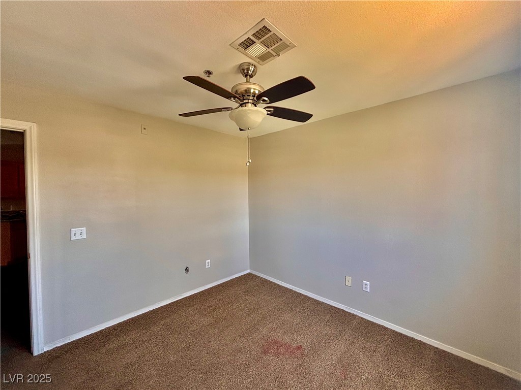2011 Cutlass Drive Henderson, NV 89014 - Photo 33 of 41 Empty room featuring dark colored carpet and a ceiling fan