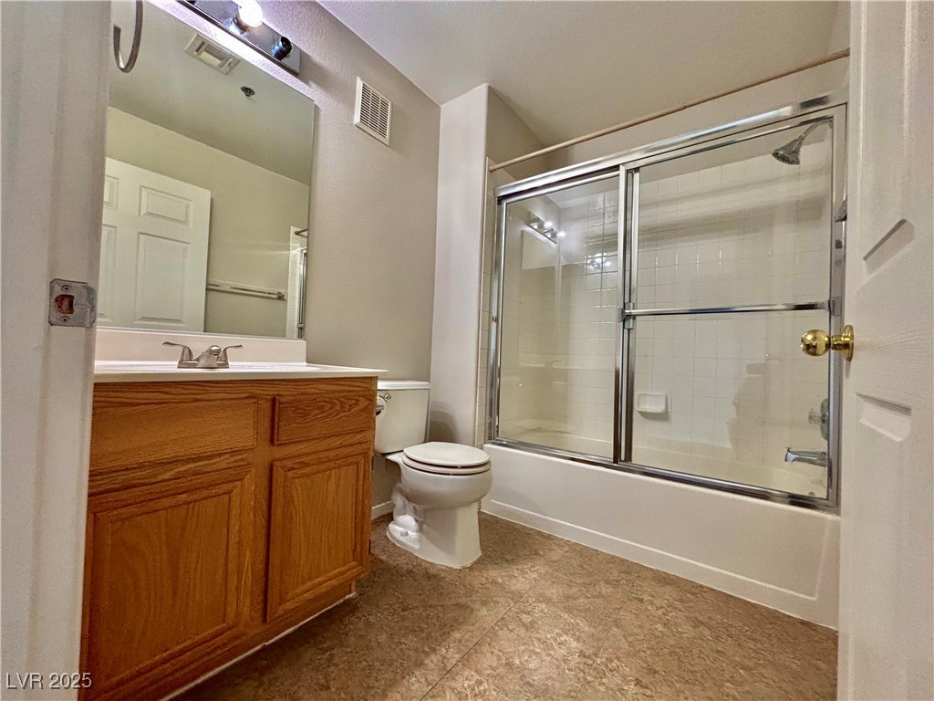 2011 Cutlass Drive Henderson, NV 89014 - Photo 35 of 41 Bathroom featuring bath / shower combo with glass door, vanity, and tile patterned floors