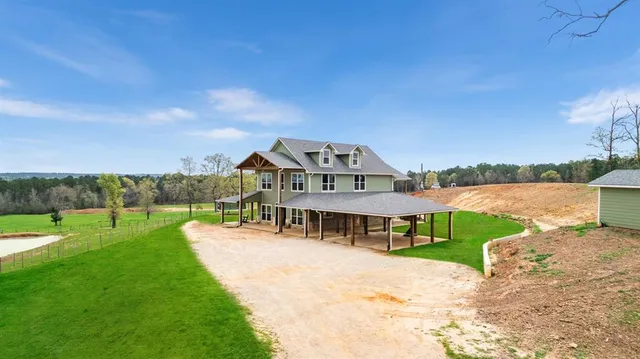 a view of a house with a yard and balcony