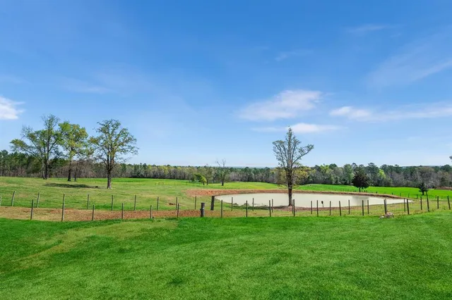 a view of a swimming pool and a yard