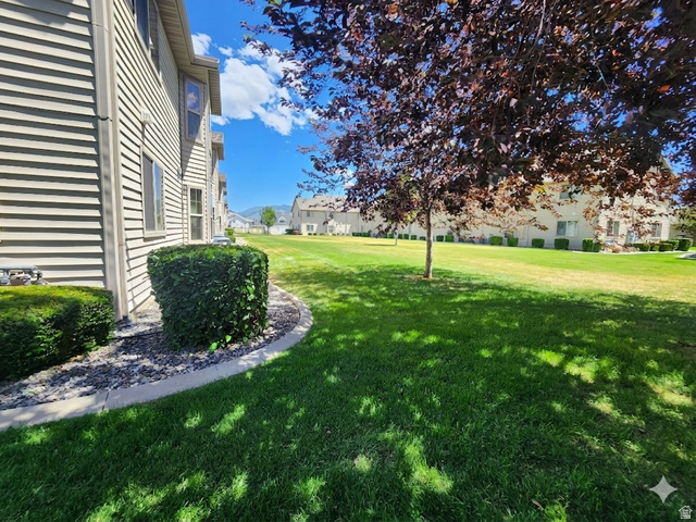 2525 West 450 South, Unit 8 Springville, UT 84663 - Photo 19 of 22 Expansive green space featuring a manicured lawn, established trees, and mature shrubbery