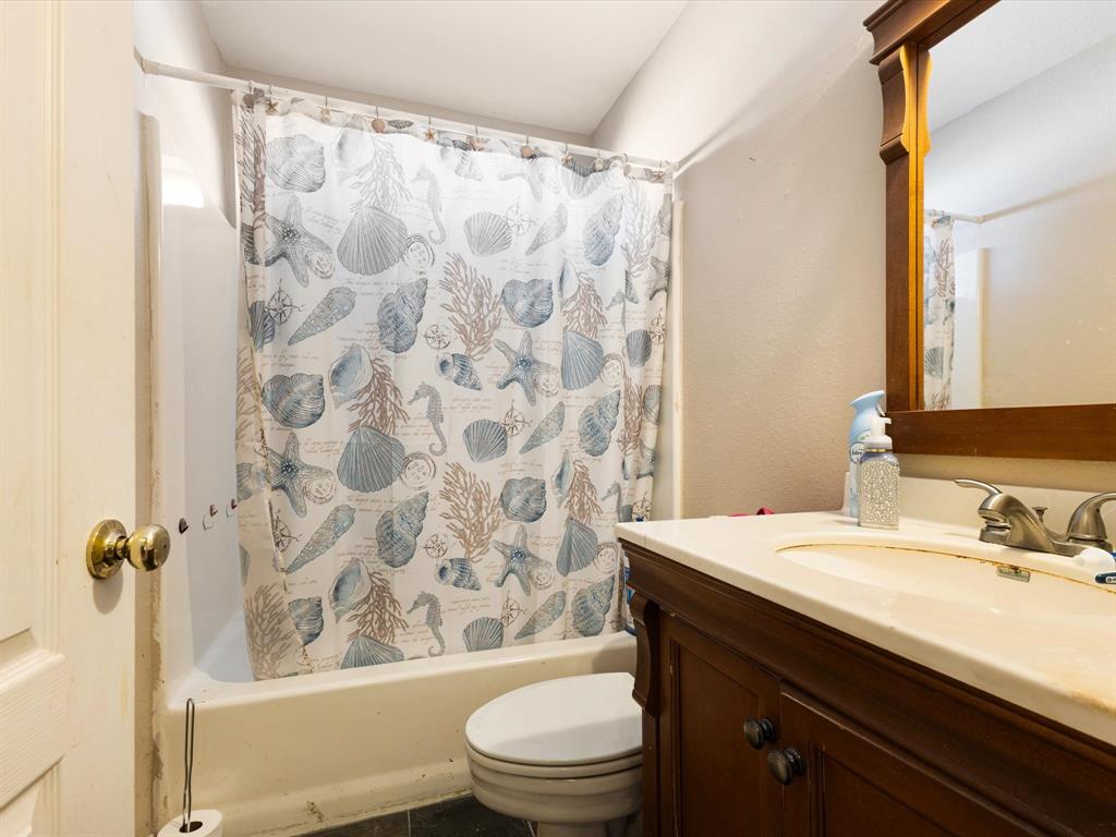 207 Quail Run Aubrey, TX 76227 - Photo 18 of 30 Bathroom featuring vanity and shower / bathtub combination with curtain